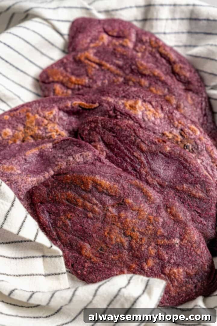 Easy tlacoyos filled with black beans. Top this homemade and vegan spin on Mexican street food with diced avocado, salsa and vegan cheese. Cooked tlacoyos ready to serve.