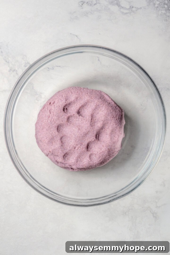 Easy tlacoyos filled with black beans. Top this homemade and vegan spin on Mexican street food with diced avocado, salsa and vegan cheese. Blue masa harina in a bowl ready to use.