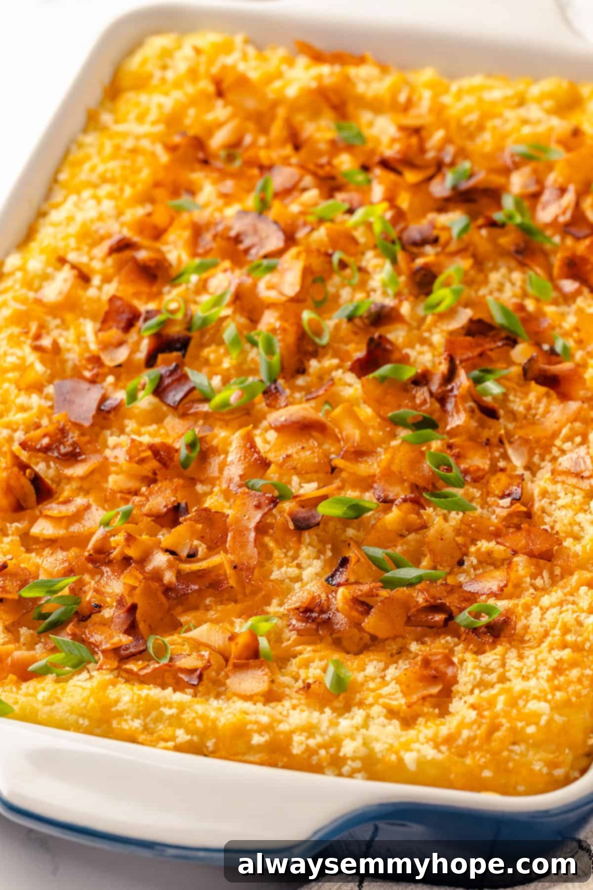 Mashed potato casserole is a comfort food side that’s always a crowd-pleaser! Vegan cheddar, bacon, and crispy panko make it extra delicious. Vegan mashed potato casserole in baking dish