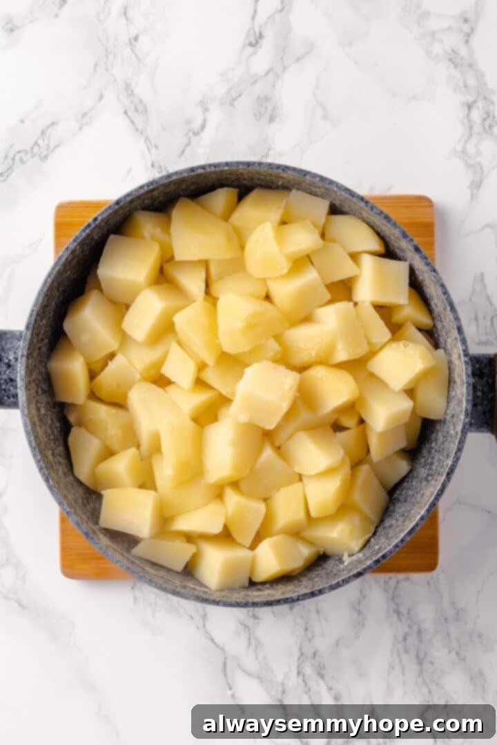 Cooked Russet potatoes in a colander, steaming, after being drained