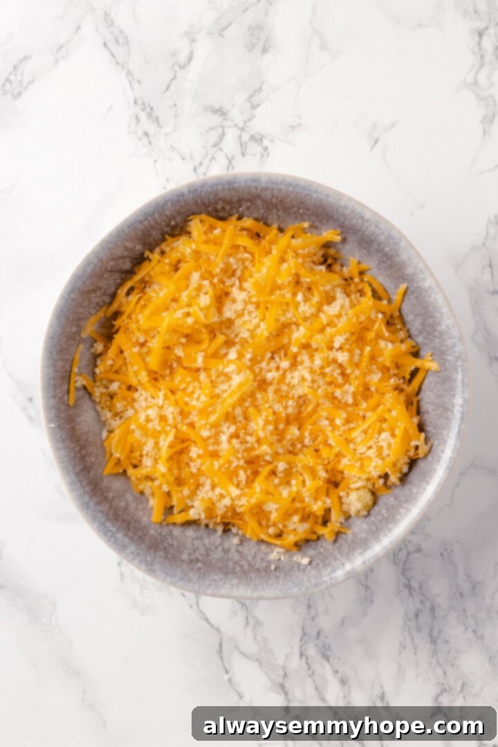 Mashed potato casserole is a comfort food side that’s always a crowd-pleaser! Vegan cheddar, bacon, and crispy panko make it extra delicious. Topping for mashed potato casserole in bowl