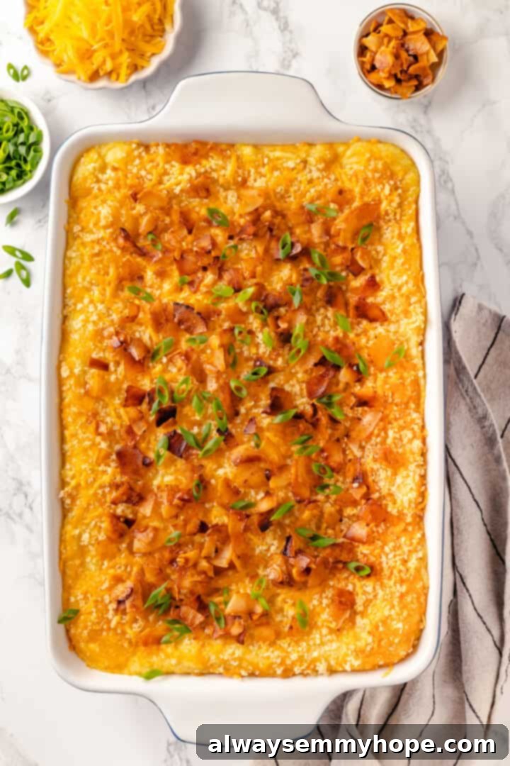 Mashed potato casserole is a comfort food side that’s always a crowd-pleaser! Vegan cheddar, bacon, and crispy panko make it extra delicious. Cheesy mashed potato casserole in baking dish
