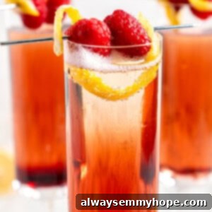 Three Kir Royale cocktails in champagne flutes, garnished with raspberries and lemon twists, against a rustic background.