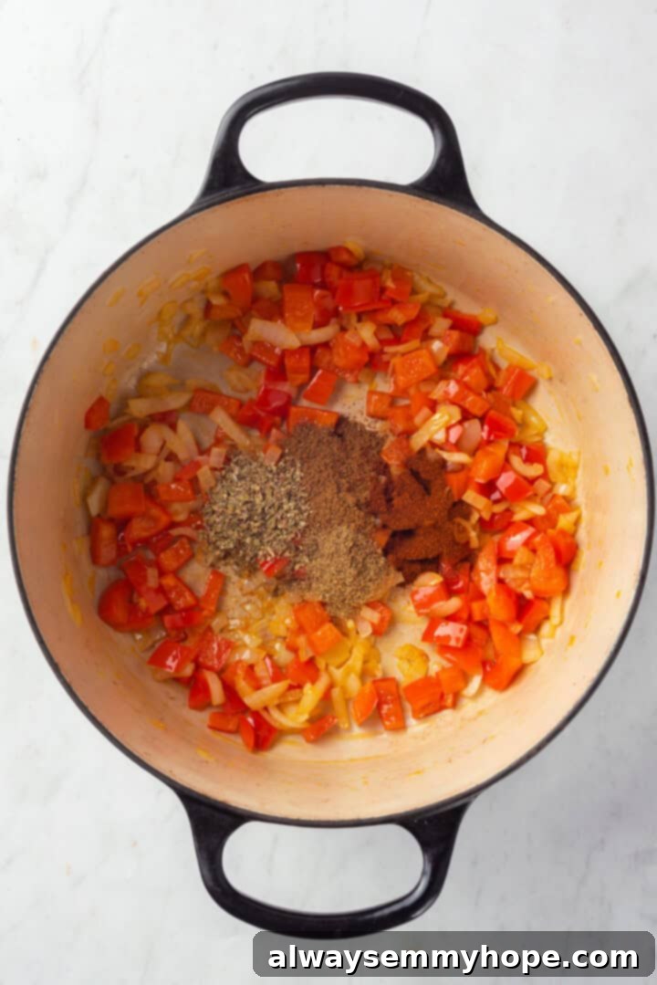 This vegan taco soup packs in a whole lot of flavour! With a zesty broth, lots of beans, and veggies, this soup is hearty and satisfying. Vegetables and spices in Dutch oven