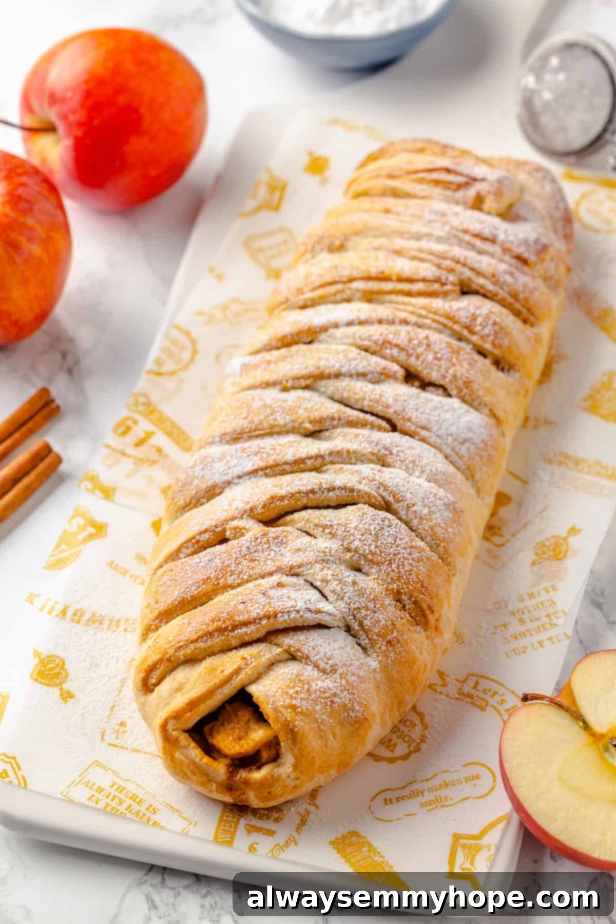 This easy apple strudel recipe wraps tender cinnamon-spiced apples in flaky puff pastry for a cozy treat. It's always a hit! Whole vegan apple strudel on cutting board
