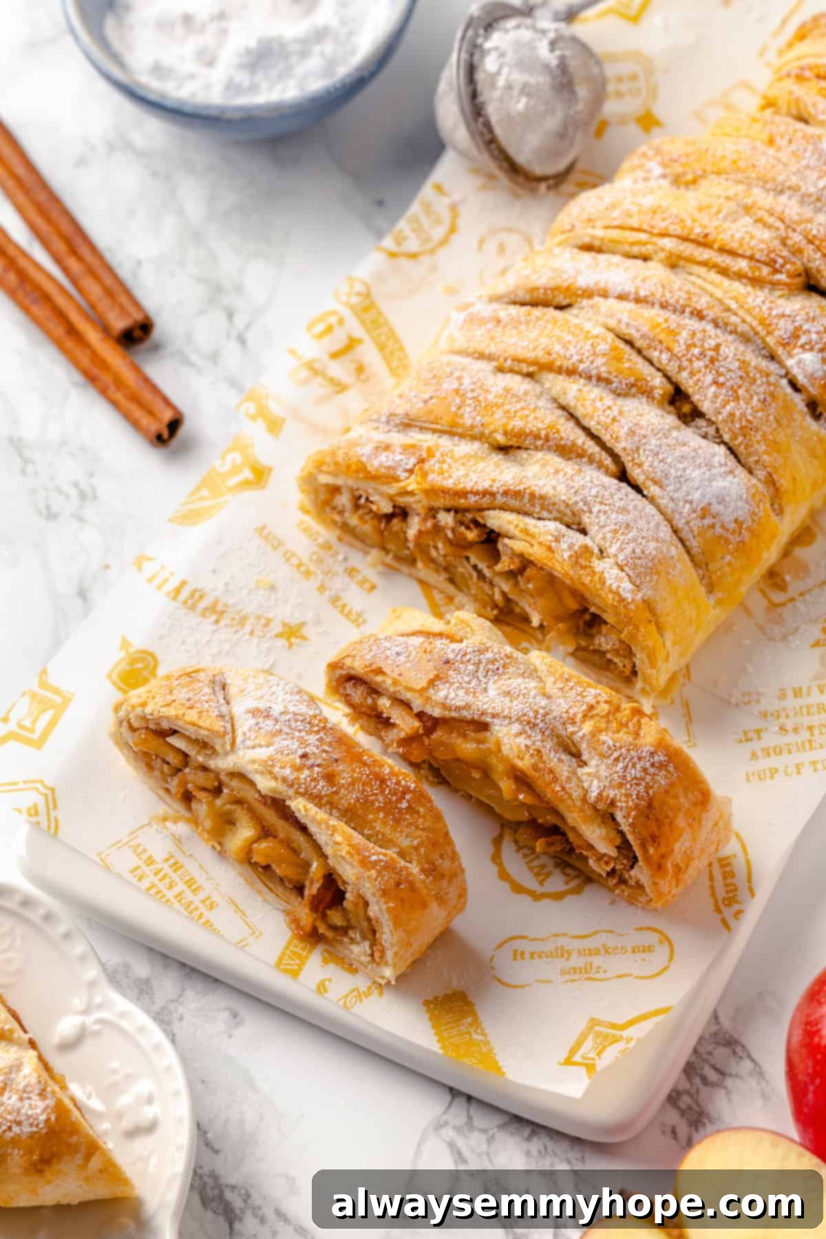 This easy apple strudel recipe wraps tender cinnamon-spiced apples in flaky puff pastry for a cozy treat. It's always a hit! Sliced vegan apple strudel on wooden board