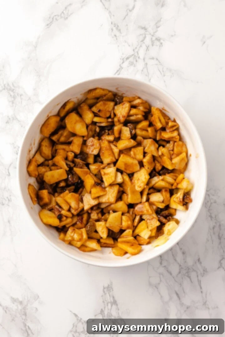 This easy apple strudel recipe wraps tender cinnamon-spiced apples in flaky puff pastry for a cozy treat. It's always a hit! Overhead view of apple filling in bowl