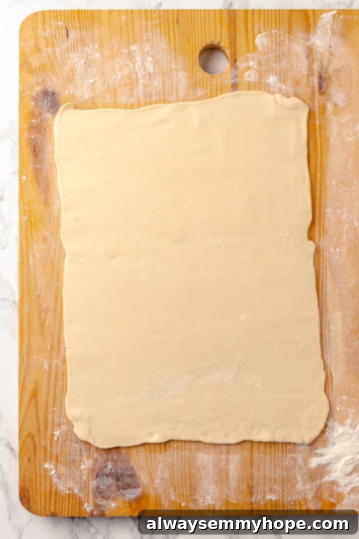 This easy apple strudel recipe wraps tender cinnamon-spiced apples in flaky puff pastry for a cozy treat. It's always a hit! Overhead view of rolled out puff pastry