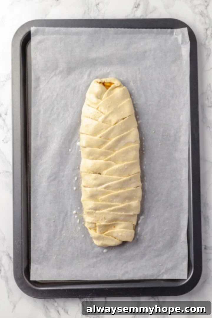 This easy apple strudel recipe wraps tender cinnamon-spiced apples in flaky puff pastry for a cozy treat. It's always a hit! Overhead view of apple strudel before baking