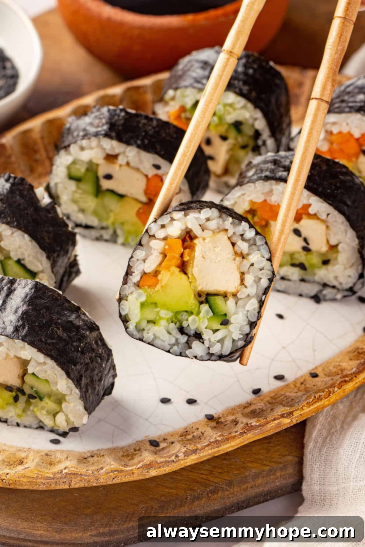 Picking up vegan sushi with chopsticks