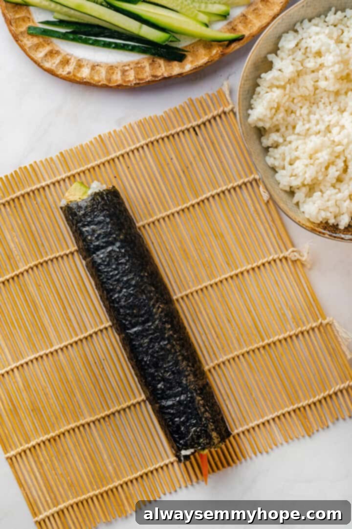 Rolled sushi roll on sushi mat