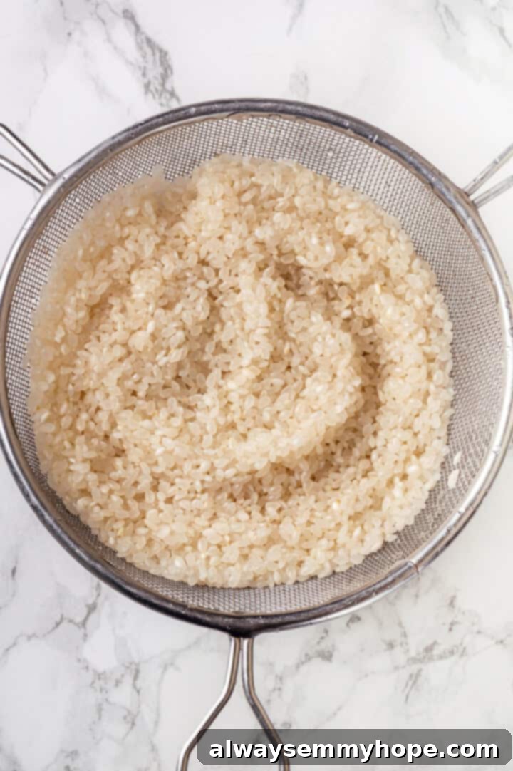 Draining sushi rice in colander