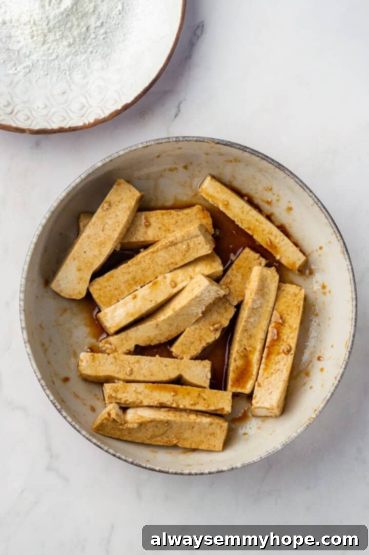 Tofu marinating in soy sauce and sesame oil