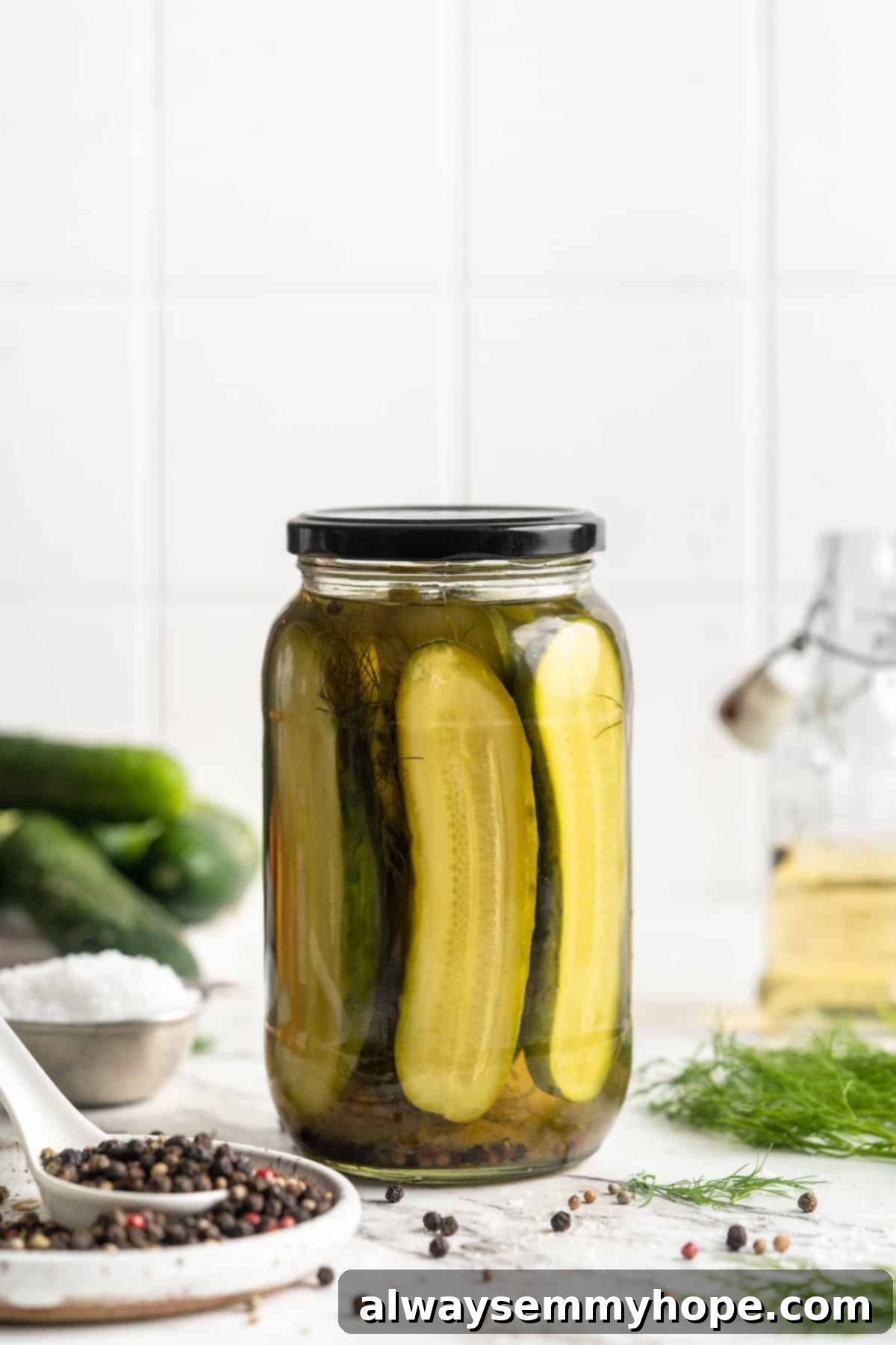 Jar of homemade pickles, showcasing their vibrant color and fresh appearance.