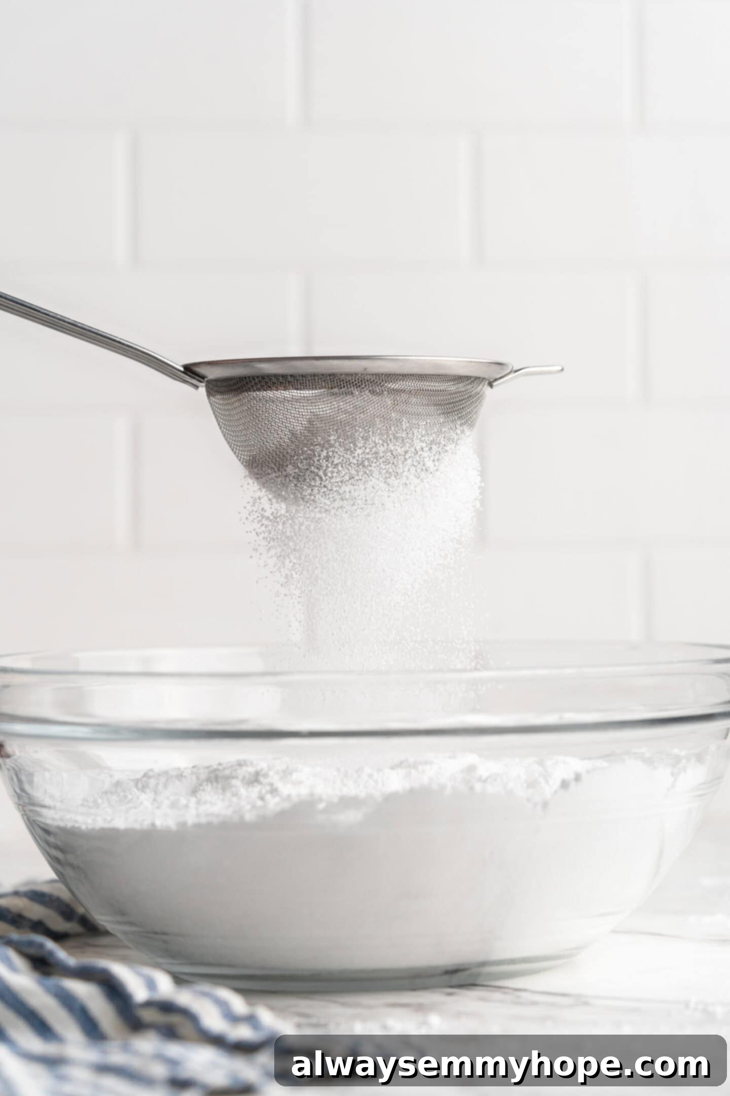 Sifting powdered sugar into bowl