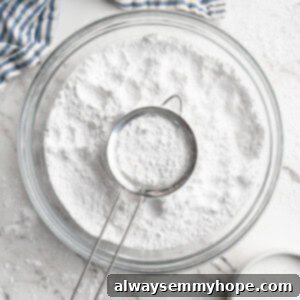 Homemade powdered sugar in bowl with sifter