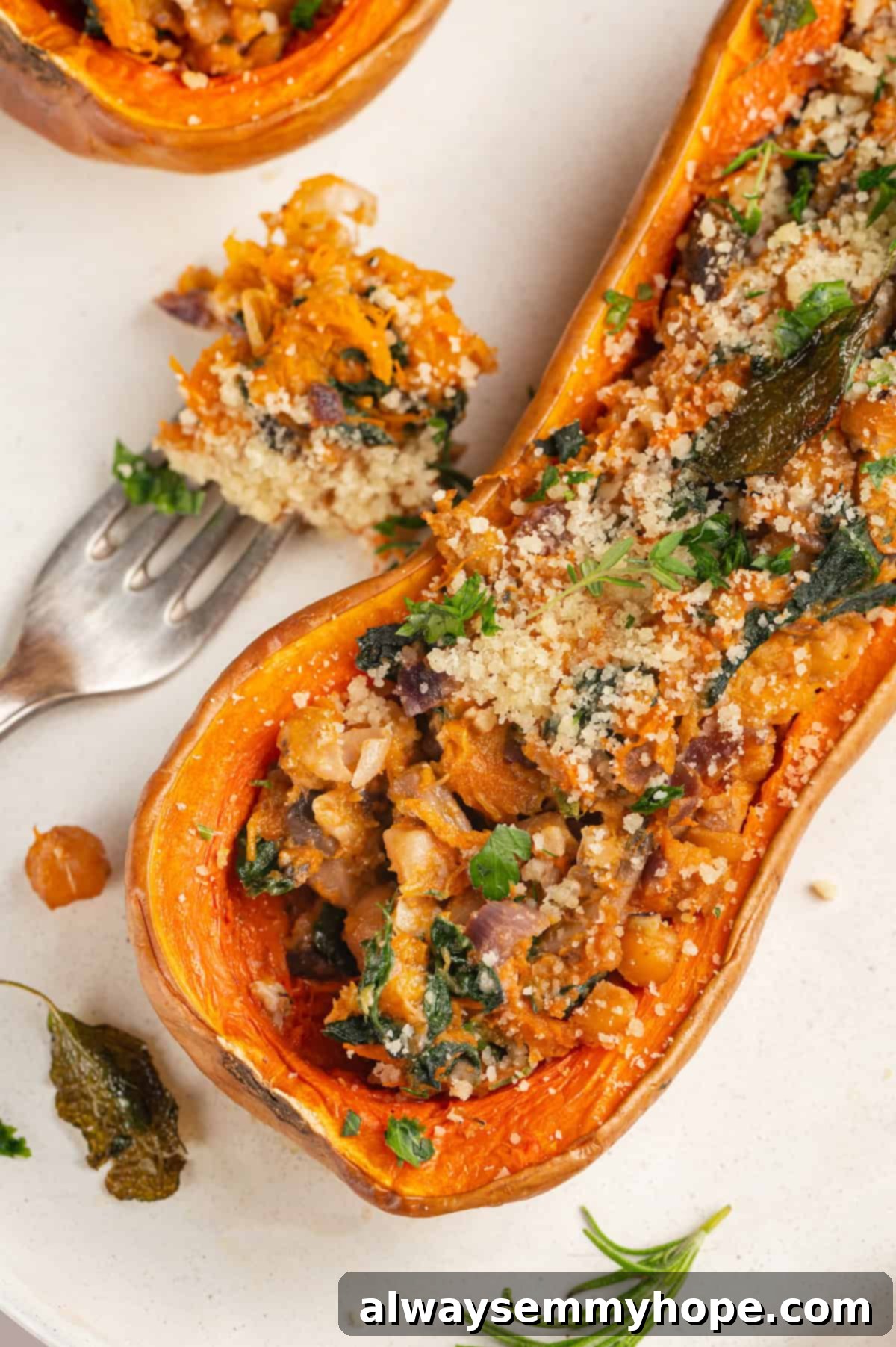 Stuffed butternut squash next to a forkful of savory filling