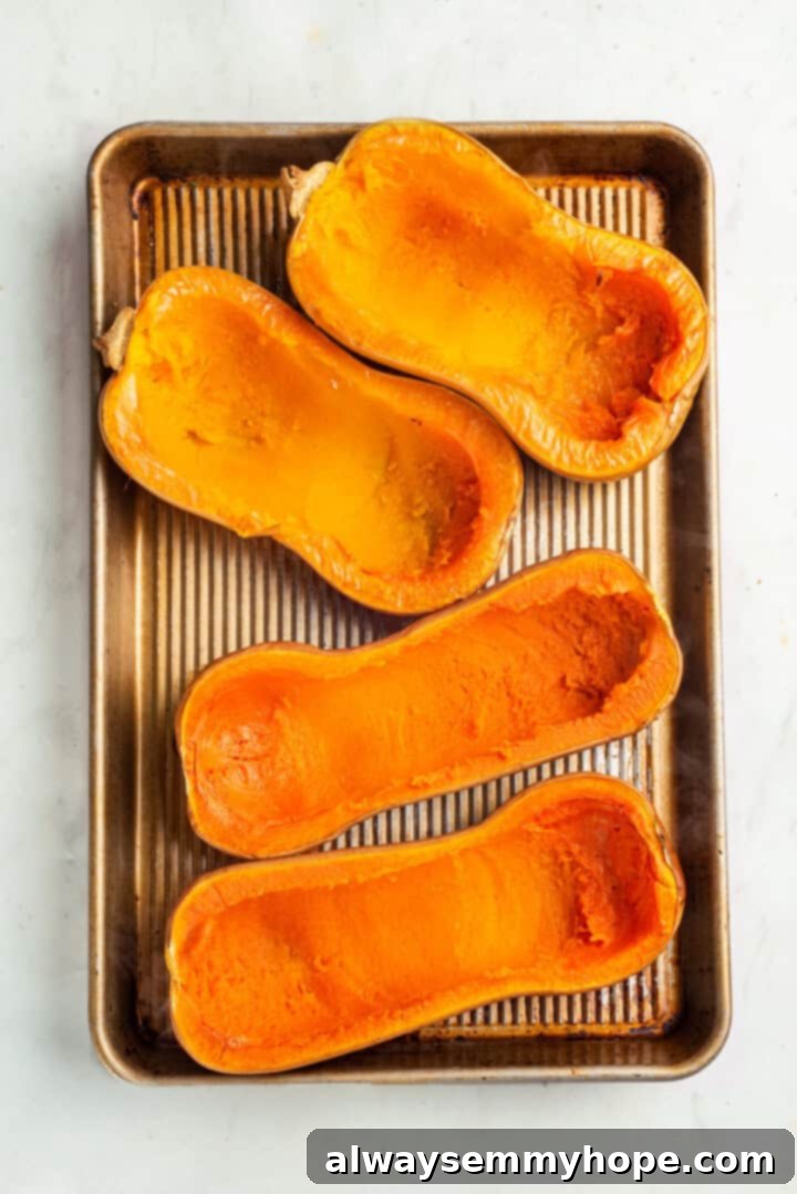 Hollowed butternut squash shells on baking sheet