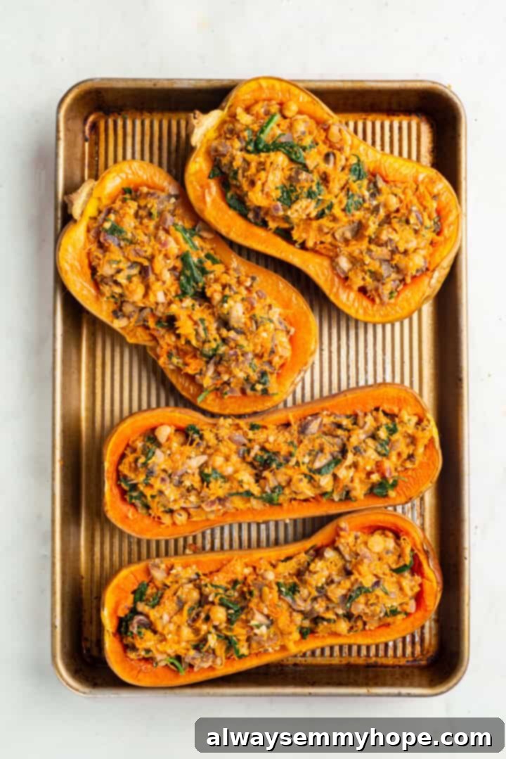 Stuffed butternut squash halves before adding vegan parmesan