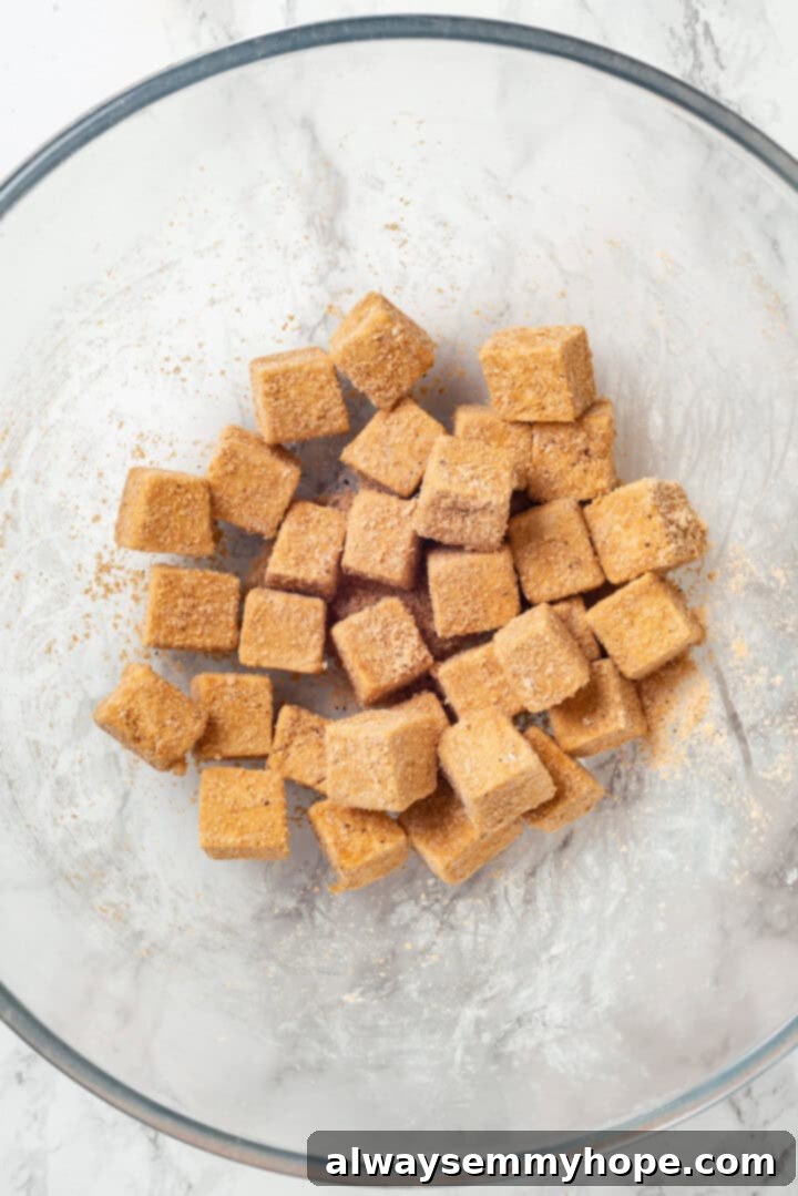 Tofu in bowl with cornstarch coating
