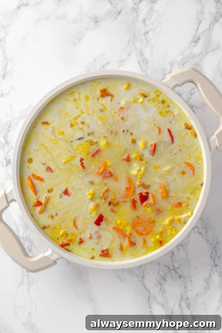 Vegetable korma is a rich and creamy Indian curry loaded with warm spices and tender veggies. It’s absolutely decadent and so easy to make! Coconut milk and water added to pot for vegetable korma