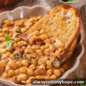 Slice of bread in bowl of marry me chickpeas