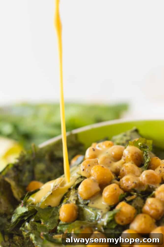 Vibrant Kale & Chickpea Salad with Zesty Lemon Poppyseed 4 Pouring dressing onto chickpea salad.
