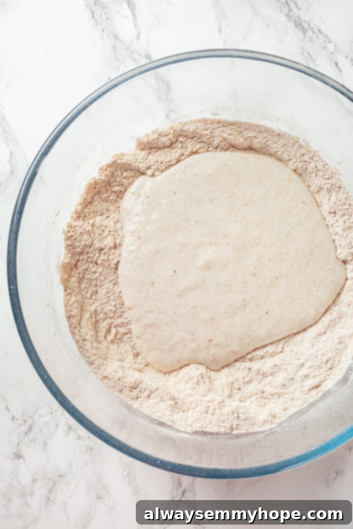 This easy gluten-free naan recipe has the chewy texture and slightly charred bits that make naan so irresistible, but without the wheat! A large bowl with dry ingredients, forming a well in the center, ready to receive the wet ingredients for gluten-free naan dough.