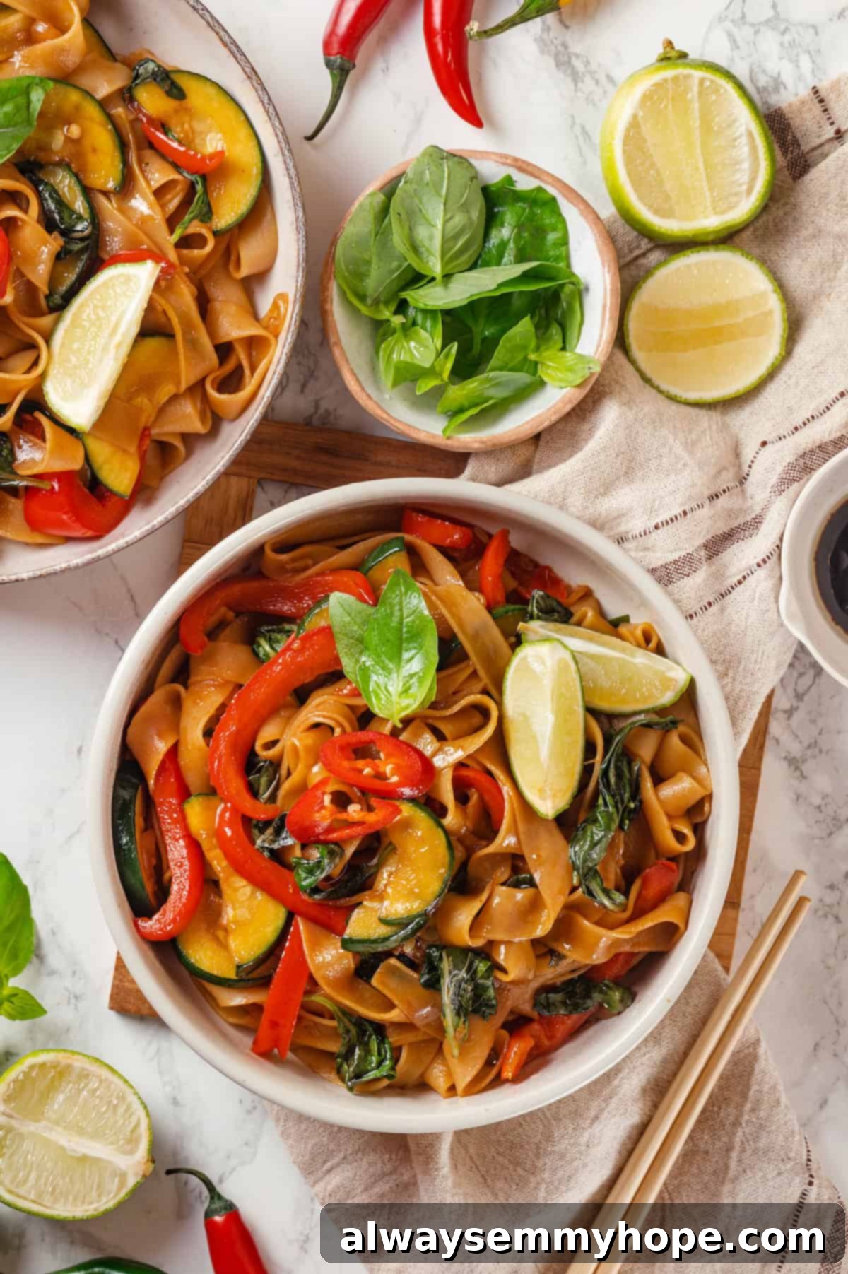 This easy Thai drunken noodles recipe is a quick stir-fry dinner perfect for a weeknight. They're sweet, savoury, spicy—and vegan too! Overhead view of Thai drunken noodles with vegetables