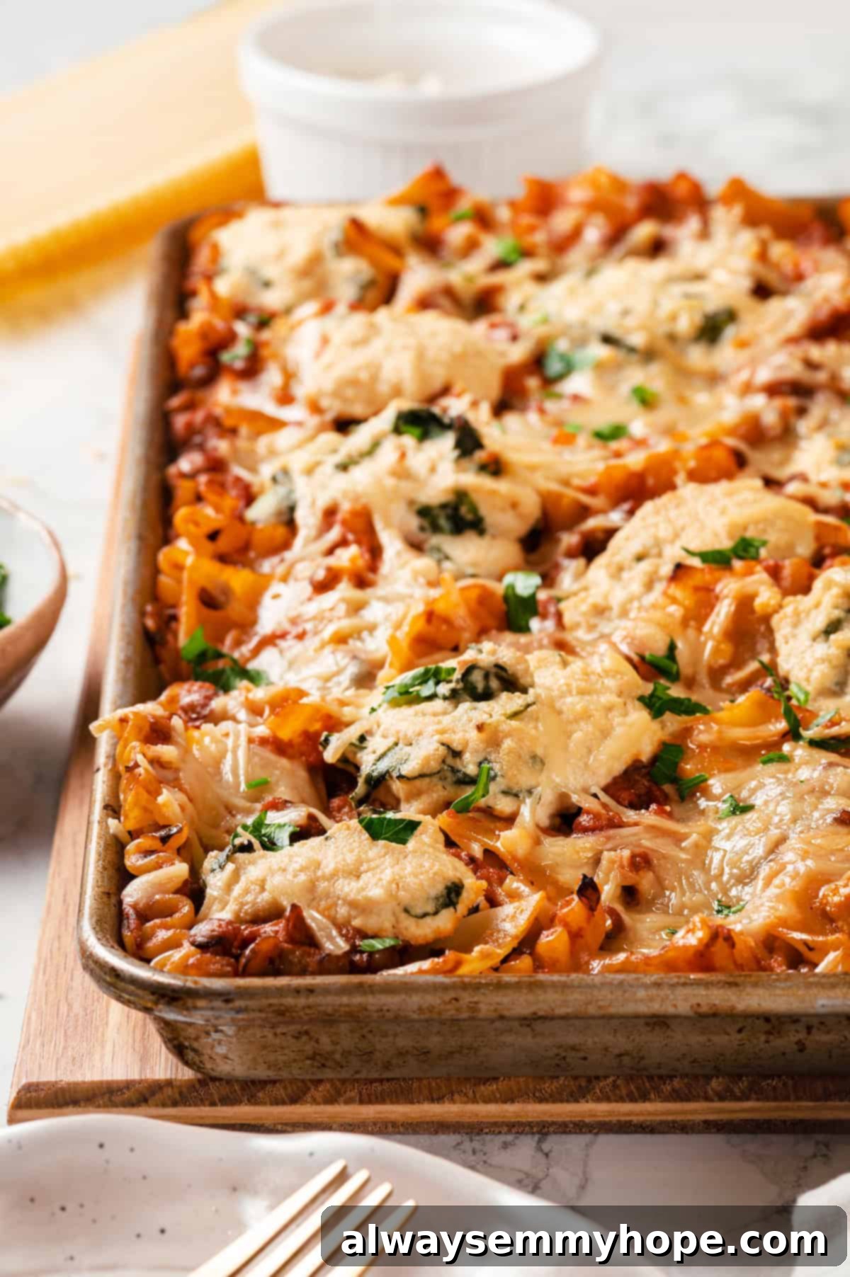 This vegan sheet pan lasagna recipe is a different way to enjoy all that cheesy pasta goodness—easier, quicker, and more crispy edges! Crispy vegan sheet pan lasagna, golden brown and bubbling with melted cheese, served fresh from the oven.
