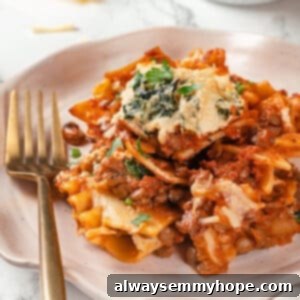 No-Fuss Sheet Pan Lasagna 2 Crispy sheet pan lasagna on plate with fork