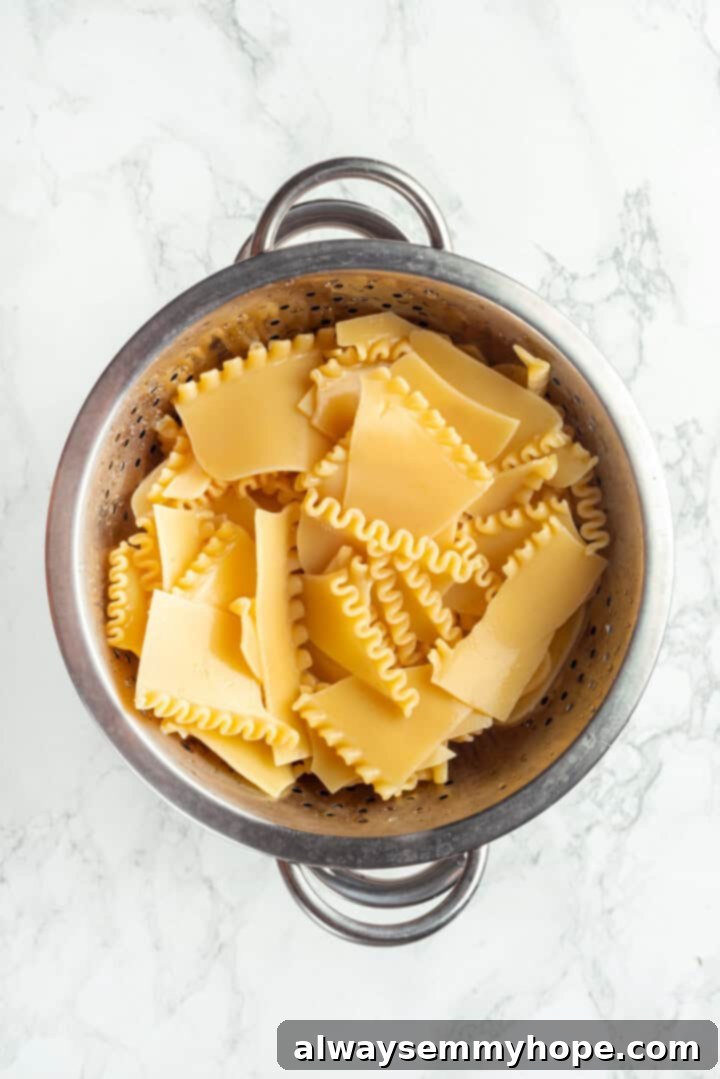 This vegan sheet pan lasagna recipe is a different way to enjoy all that cheesy pasta goodness—easier, quicker, and more crispy edges! Lasagna noodles in colander