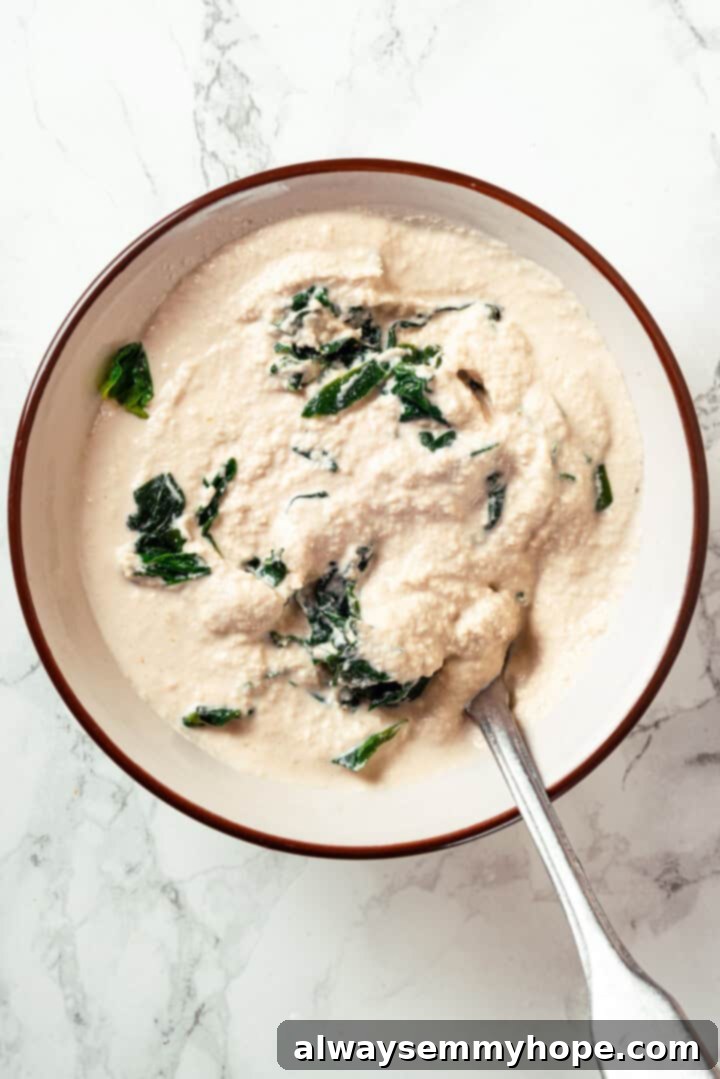 This vegan sheet pan lasagna recipe is a different way to enjoy all that cheesy pasta goodness—easier, quicker, and more crispy edges! Vegan ricotta and spinach in bowl