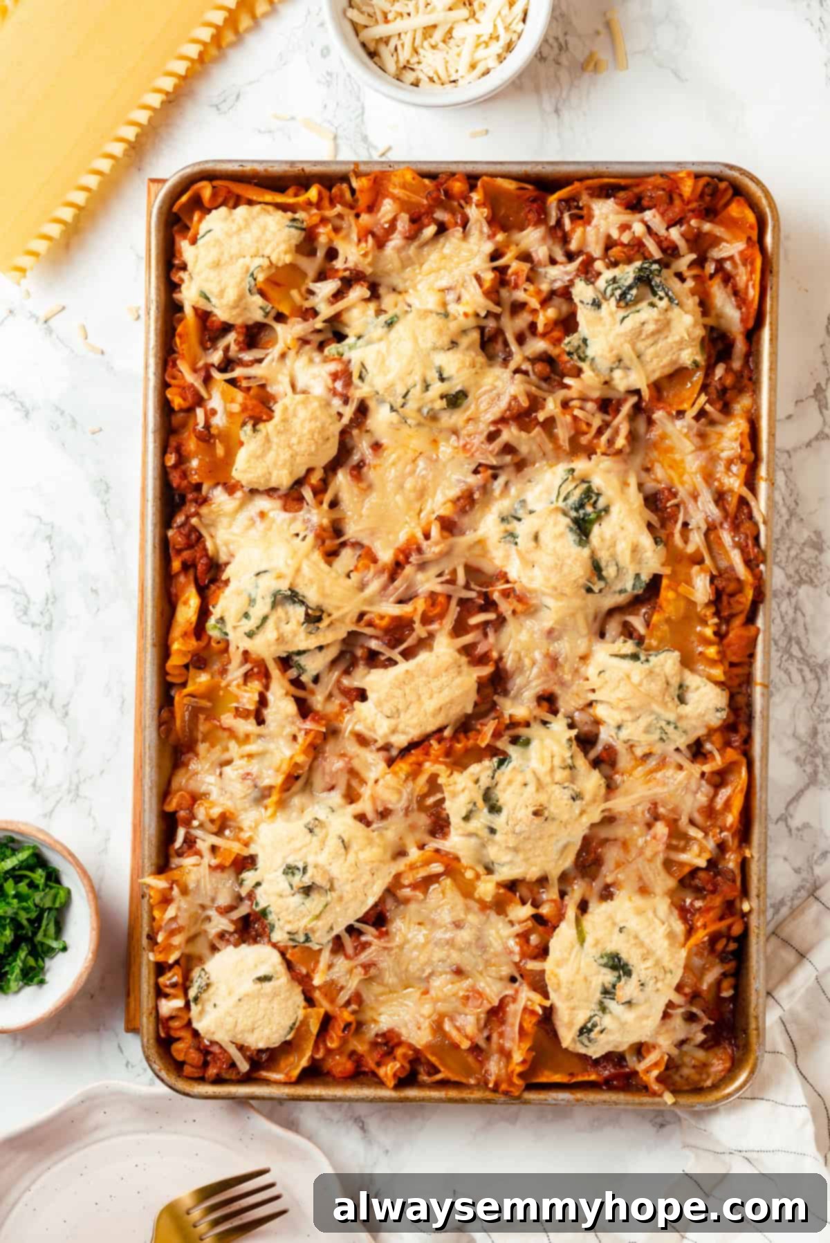 This vegan sheet pan lasagna recipe is a different way to enjoy all that cheesy pasta goodness—easier, quicker, and more crispy edges! Overhead view of sheet pan lasagna with crispy edges