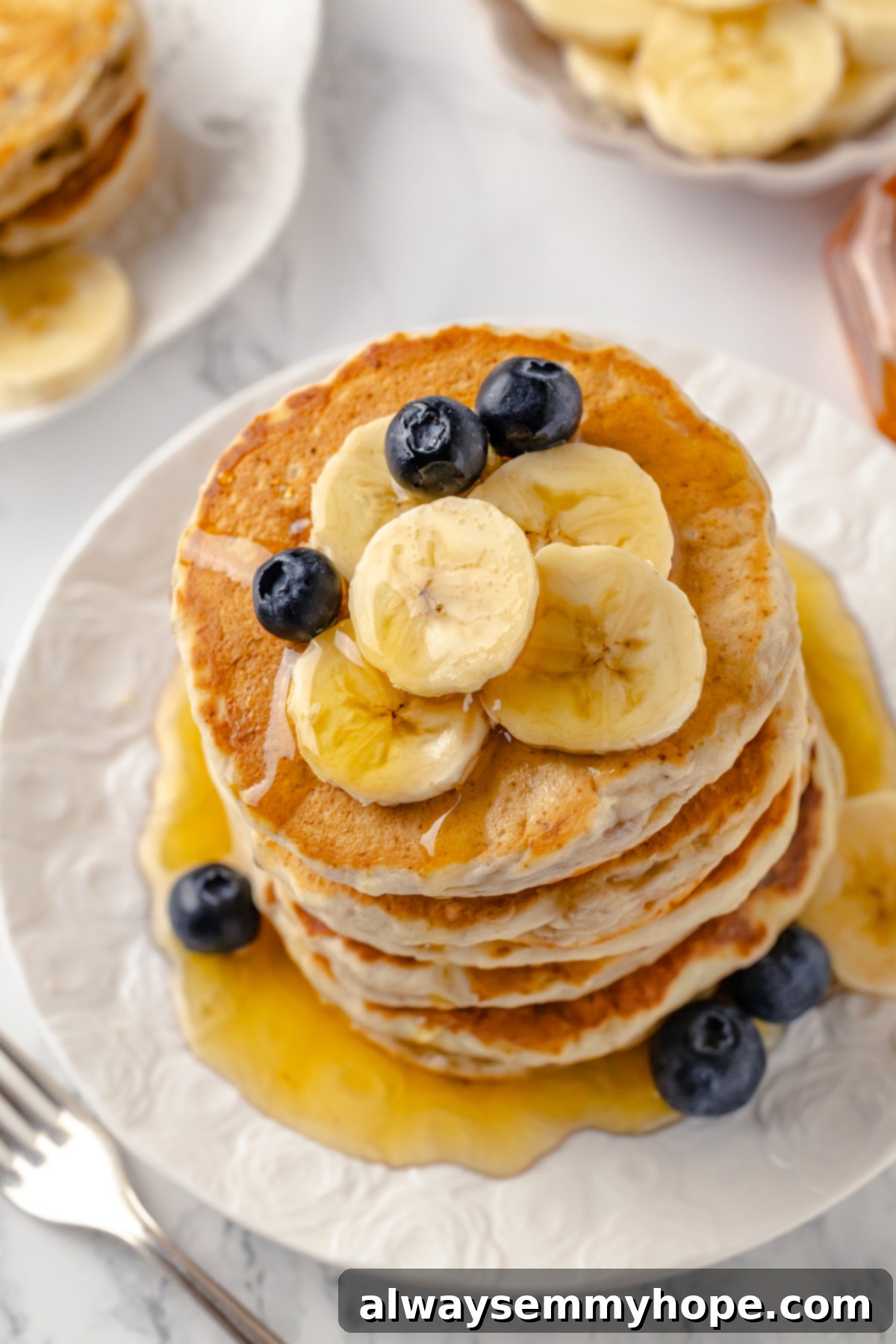 Top-down view of a single vegan banana pancake on a white plate, ready to be enjoyed