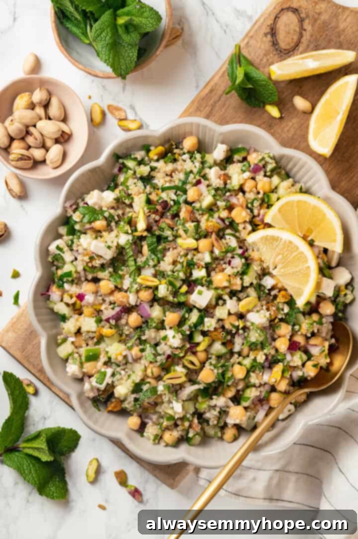 Overhead view of the vegan Jennifer Aniston salad thoroughly mixed with dressing in a serving bowl, showcasing its readiness.