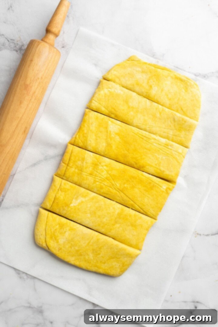 Cut dough for vegan Jamaican patties into individual rectangles