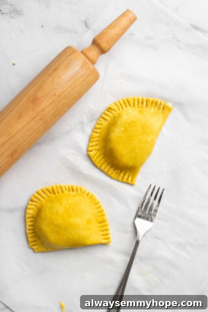 Overhead view of vegan Jamaican patties before baking, shaped into half moons