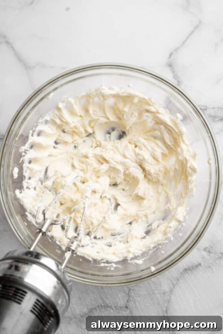 Vegan mini cheesecakes are the perfect two-bite dessert, with a rich, creamy cheesecake filling no one can resist. So easy to make too! Whipping the creamy vegan filling. Beating vegan cream cheese in a bowl with a hand mixer until smooth and creamy.