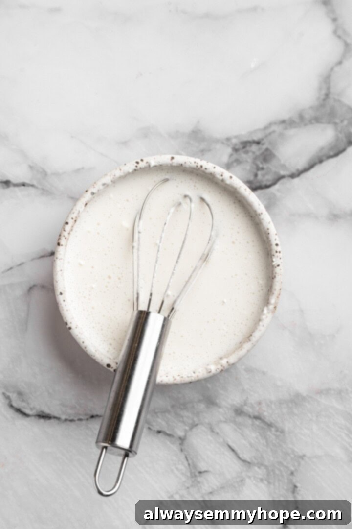 Vegan mini cheesecakes are the perfect two-bite dessert, with a rich, creamy cheesecake filling no one can resist. So easy to make too! Pre-mixing coconut cream and cornstarch. Mixing coconut cream and cornstarch in a small bowl with a whisk for a lump-free thickening agent.