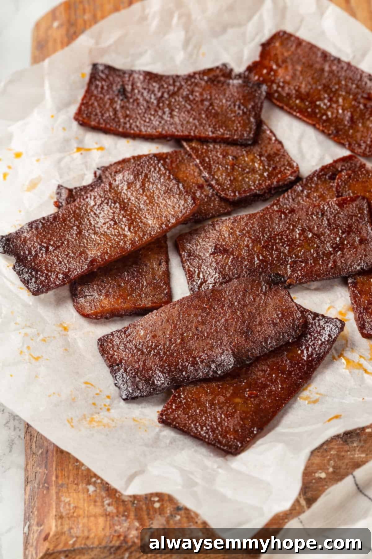 Crispy Tofu Bacon Fresh from the Oven A baking sheet lined with parchment paper, showcasing perfectly golden and crispy vegan tofu bacon strips, ready to be enjoyed.