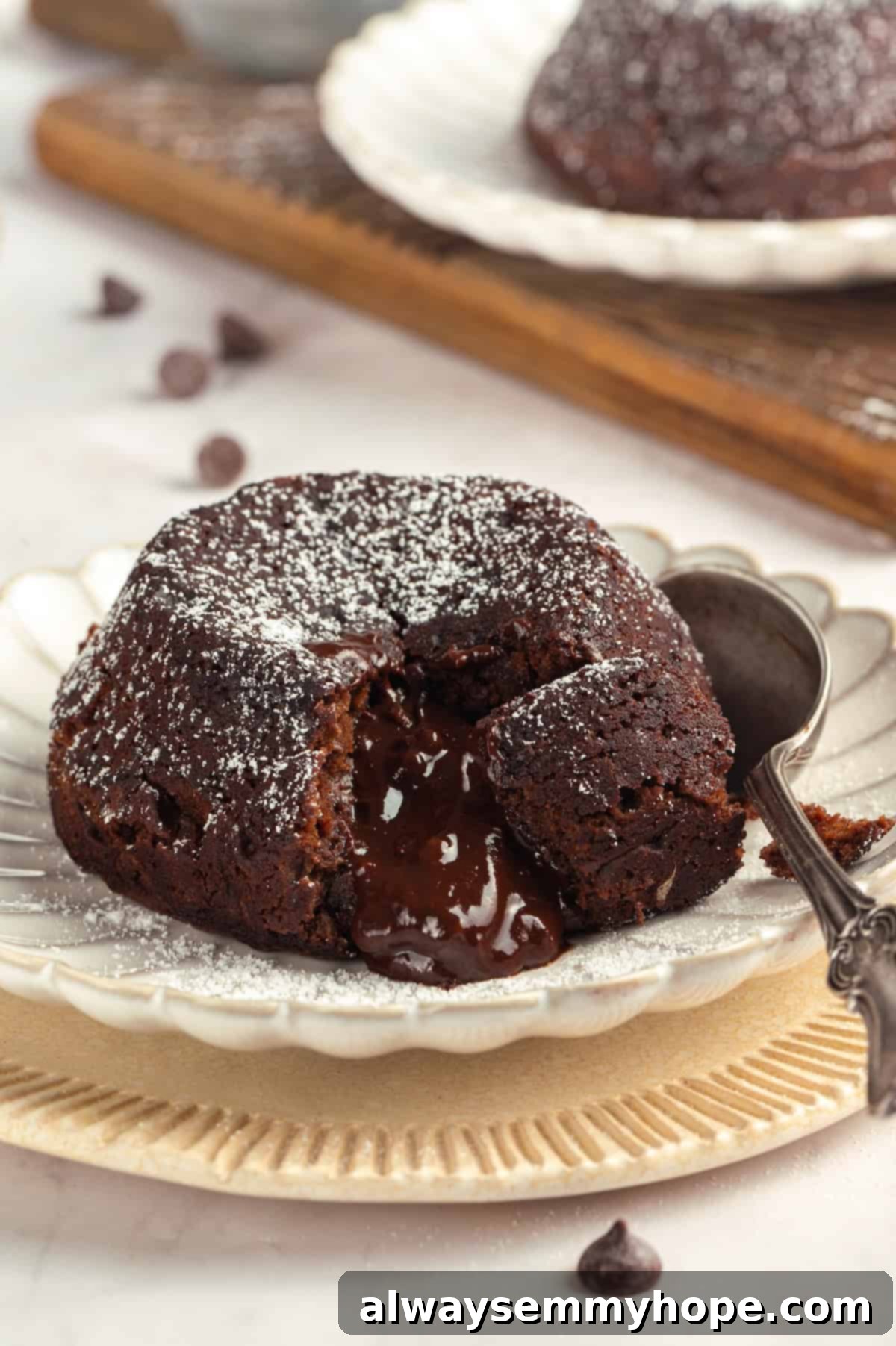The irresistible molten center of a perfectly baked vegan chocolate lava cake. A close-up shot of a rich vegan chocolate lava cake cut open, revealing its perfectly melted, gooey ganache center flowing out, inviting indulgence.