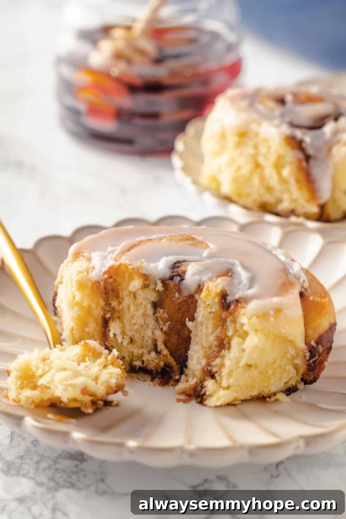 Vegan honey bun on plate with bite on fork