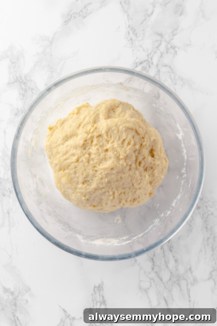 Dough for honey buns in glass bowl