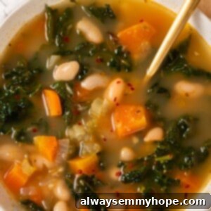 Overhead view of kale soup in bowl with spoon