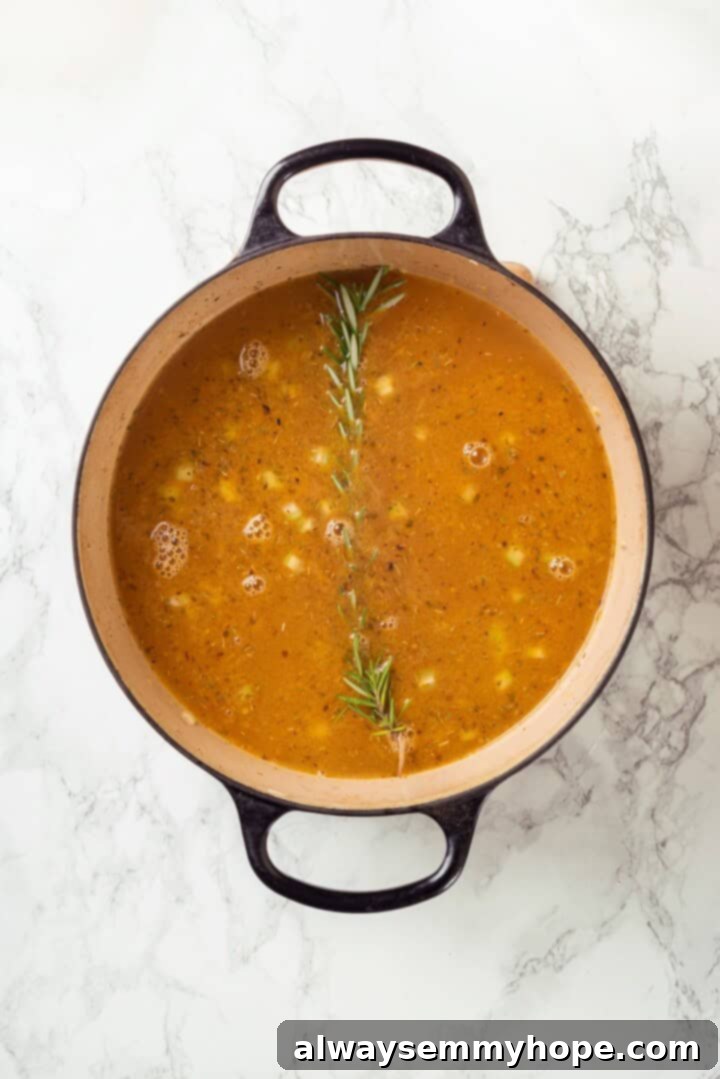 Rosemary added to pot of soup