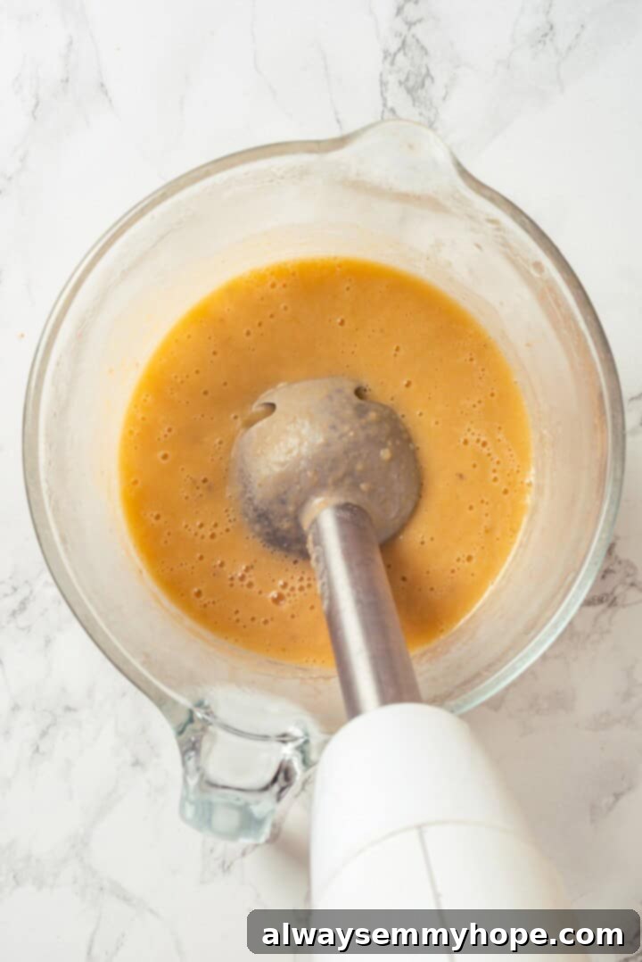 Pureeing portion of soup with immersion blender