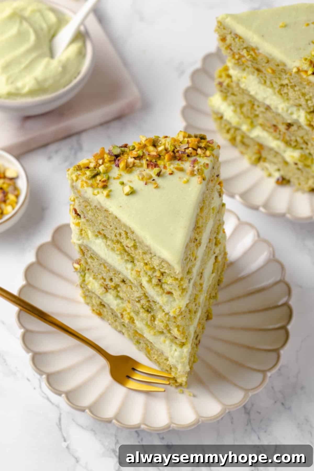 Slice of vegan pistachio cake on plate with fork
