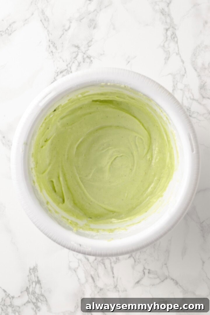 Overhead view of pistachio frosting in mixing bowl