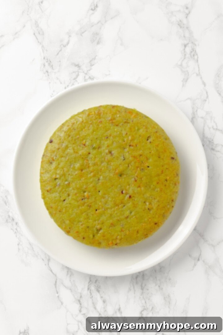 Overhead view of pistachio cake on platter before frosting